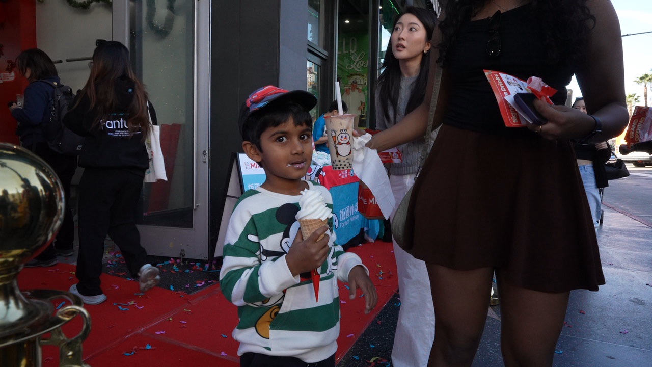 Abertura lotada da loja MIXUE em shopping com mascote gigante de boneco de neve e clientes entusiasmados